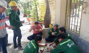 Công nhân ăn cơm trước cổng chùa Thái Bình trong lúc chờ tiếp kiến sư trụ trì
